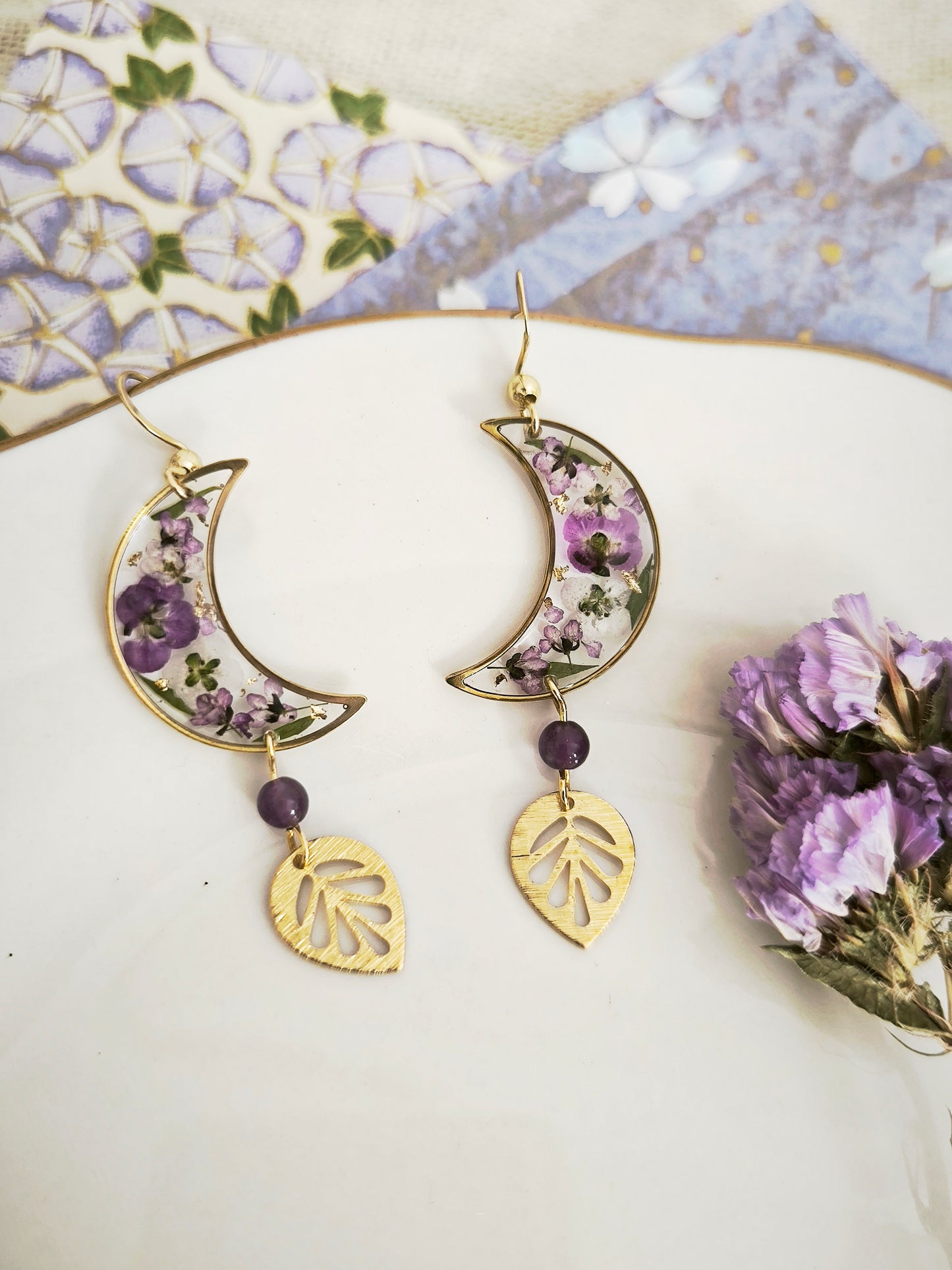 Boucles d’oreilles lunes florales en résine – fleurs violettes & acier doré